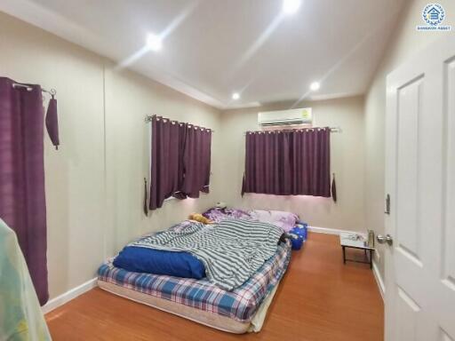 Cozy bedroom with double bed and purple curtains