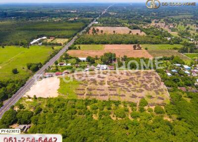 Aerial view of large land with surrounding greenery and road