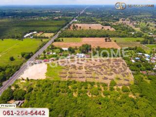 Aerial view of large land with surrounding greenery and road