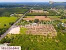 Aerial view of large land with surrounding greenery and road