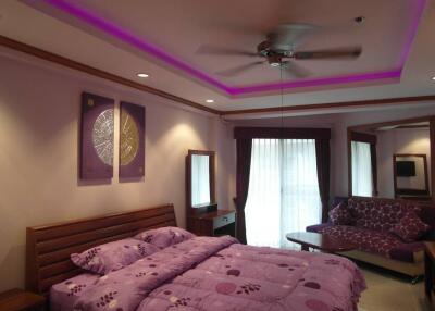 Modern bedroom with purple decor and coffered ceiling with LED lighting