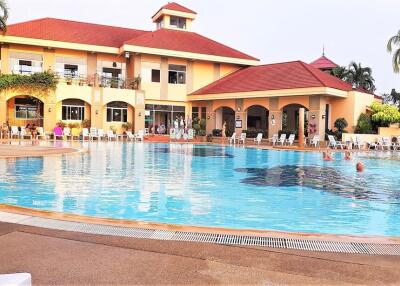 Outdoor swimming pool with a building in the background