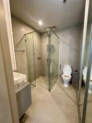 Modern bathroom with glass shower enclosure and toilet