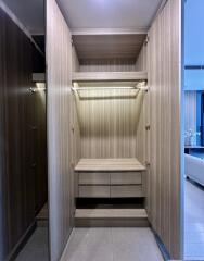 Spacious wooden closet with shelves and drawers