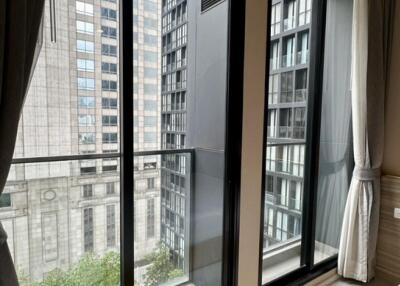 Modern bedroom with large windows and a city view