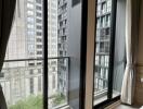 Modern bedroom with large windows and a city view