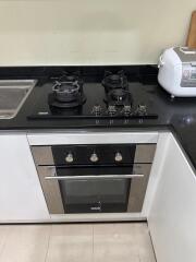 Modern kitchen area with gas stove and oven