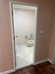 Bathroom with a toilet and tiled walls