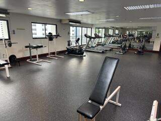 Well-equipped gym with exercise machines and weights