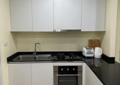 modern kitchen with white cabinets and appliances