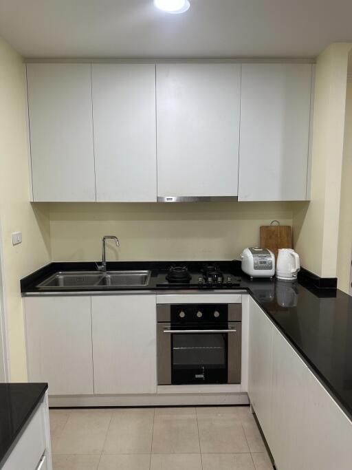 modern kitchen with white cabinets and appliances