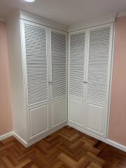 Corner with white louvered closet doors