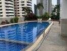 Outdoor swimming pool with surrounding high-rise buildings