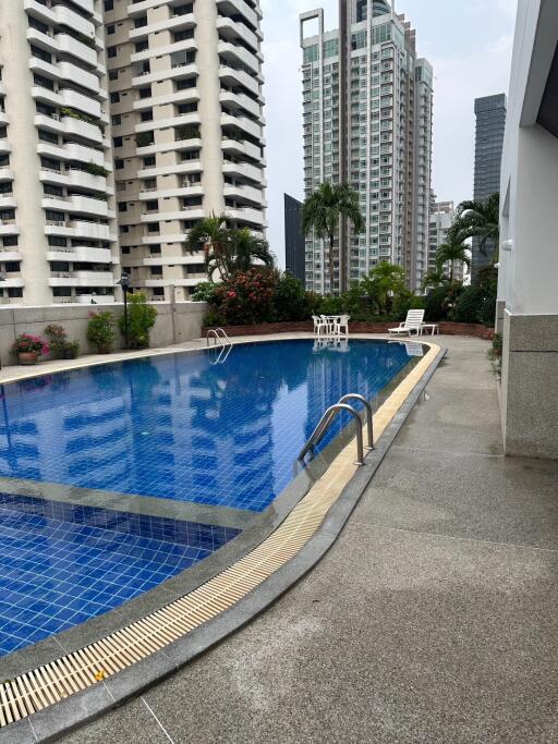 Outdoor swimming pool with surrounding high-rise buildings