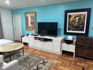 Living room with TV and colorful wall art