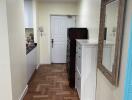 Spacious hallway with wooden flooring and decor