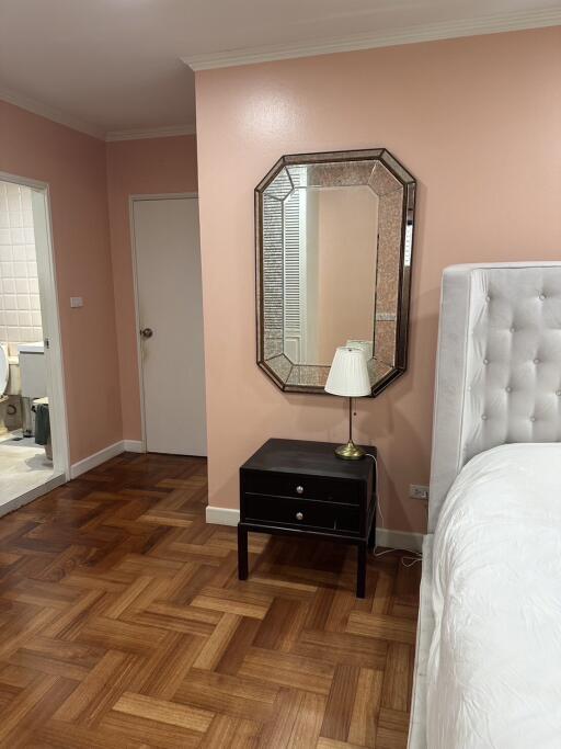 Bedroom area with nightstand and mirror