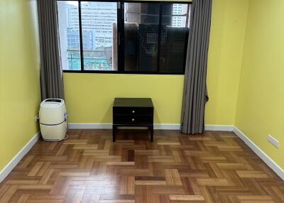 Living room with wooden flooring and large window