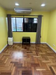 Living room with wooden flooring and large window