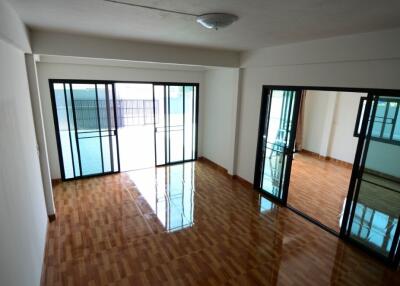 Spacious living room with large windows and sliding glass doors leading to the patio