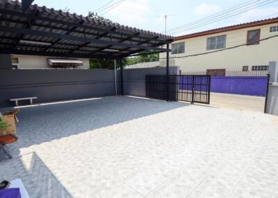 Gated outdoor area with carport