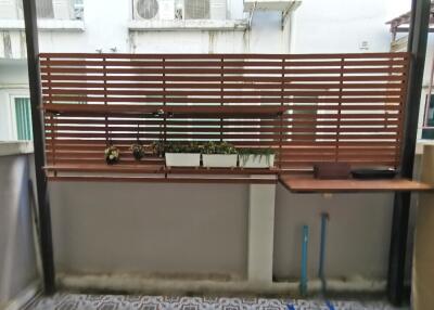 Well-designed balcony with wooden slats and potted plants