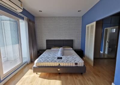 Bright, modern bedroom with double bed and balcony access