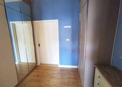 Bedroom with mirrored closets and wooden floor