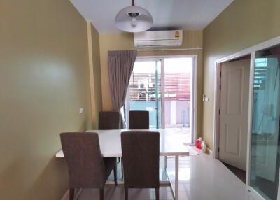 Dining room with table and chairs, sliding glass door and air conditioner