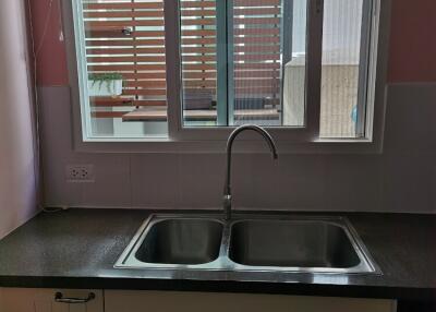 Kitchen with double sink and large window