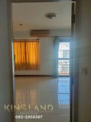 Bedroom with large window and yellow curtains