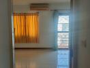 Bedroom with large window and yellow curtains