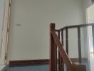 Staircase landing with wooden railing