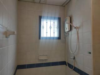 Bathroom with shower and window