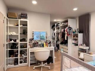 Well-organized bedroom with walk-in closet and vanity desk