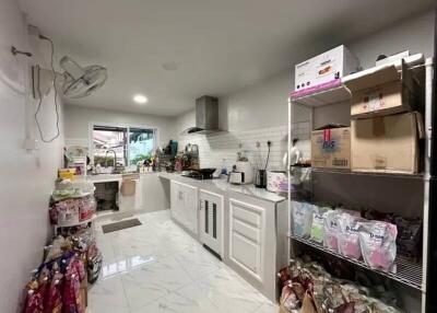 Modern kitchen with white cabinetry and tiled backsplash