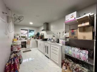 Modern kitchen with white cabinetry and tiled backsplash