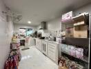 Modern kitchen with white cabinetry and tiled backsplash