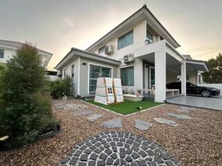 Modern two-story house exterior with driveway and front yard