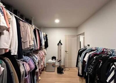 Spacious walk-in closet with clothing racks and storage