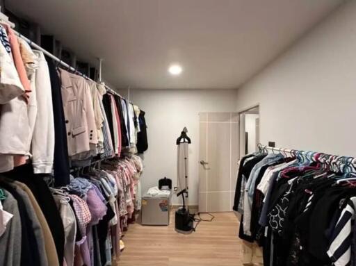 Spacious walk-in closet with clothing racks and storage