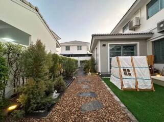 Well-maintained backyard with gravel pathway and greenery