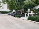 Parking area with several parked cars and greenery