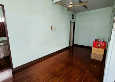 empty bedroom with fan and boxes