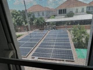 View from window of solar panels and neighboring houses