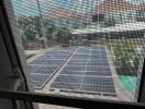 View from window of solar panels and neighboring houses