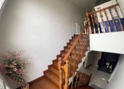 Wooden staircase with white walls