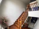 Wooden staircase with white walls