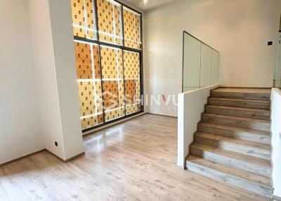 Modern living room with wooden flooring and staircase