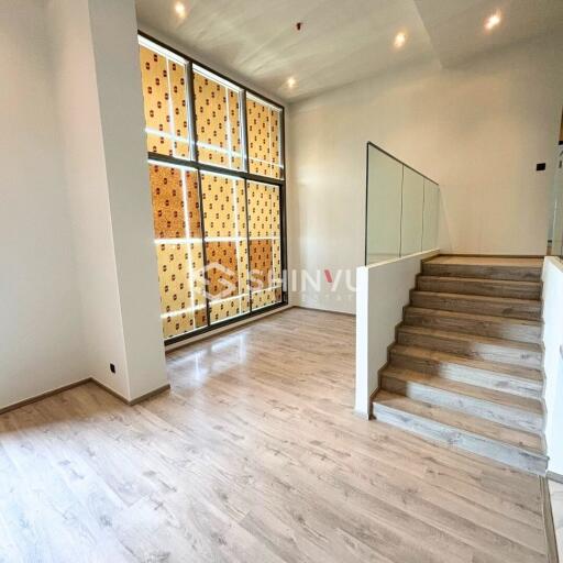 Modern living room with wooden flooring and staircase